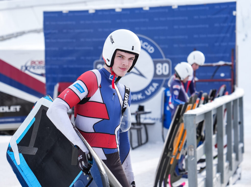 Two athletes competing in athletic event sports with helmet