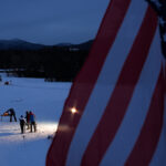 A group of athletes competing in athletic event sports with helmet in the snow