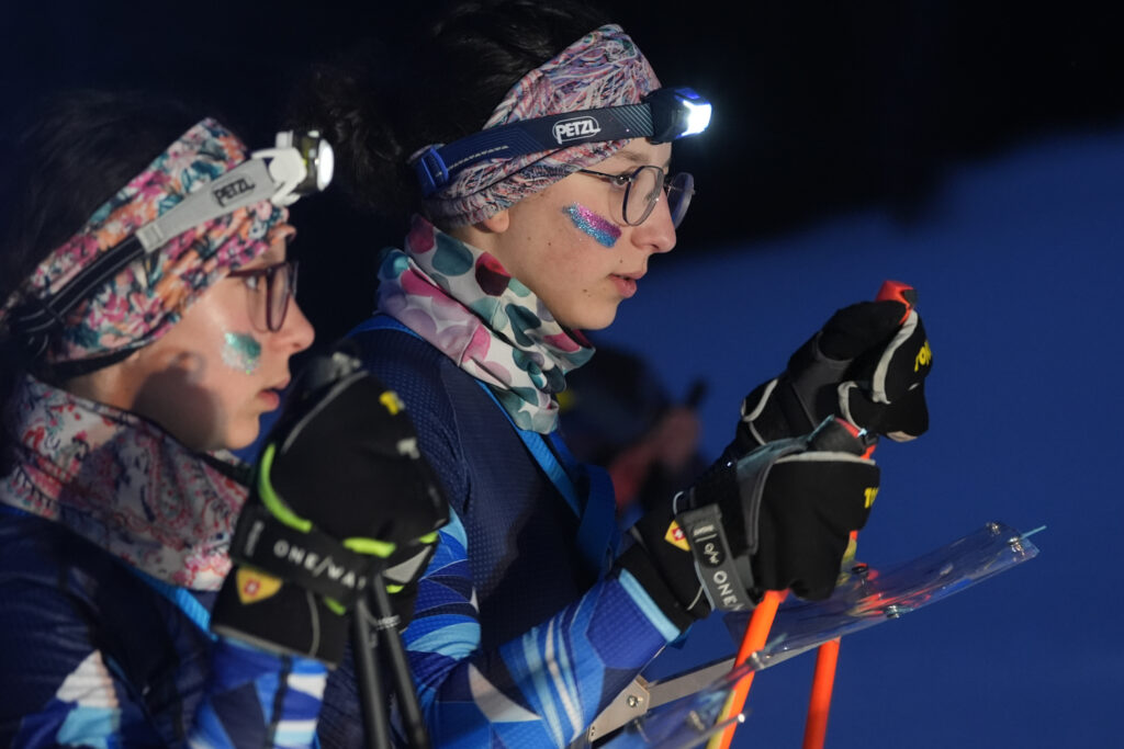 Two athletes competing in athletic event sports with goggles in the snow