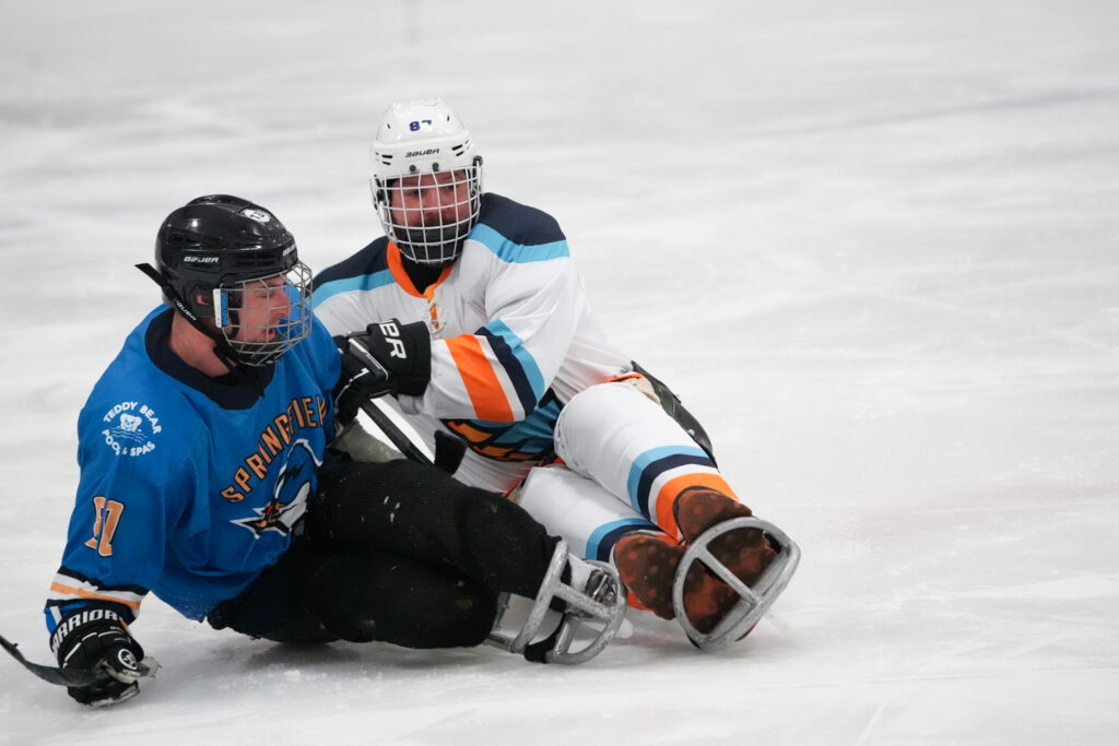 Two athletes competing in athletic event sports with helmet