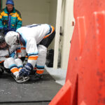 Two athletes competing in athletic event sports with helmet