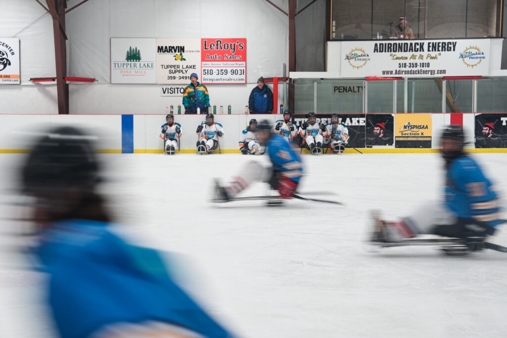 A group of athletes skating with helmet on the rink