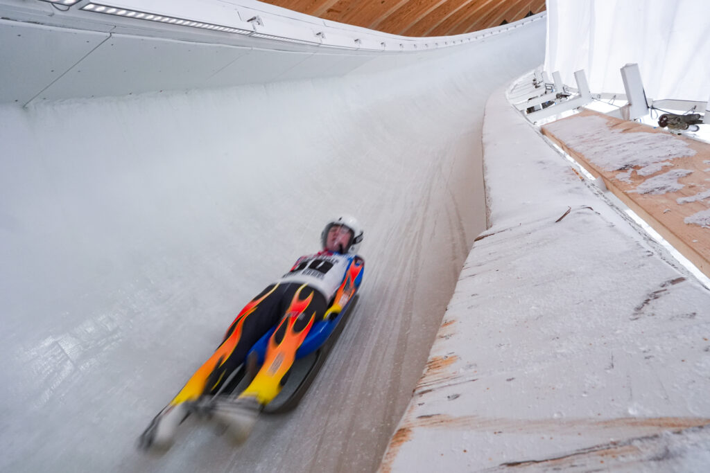 Two athletes competing in athletic event sports with helmet