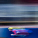 Two athletes competing in athletic event sports with helmet