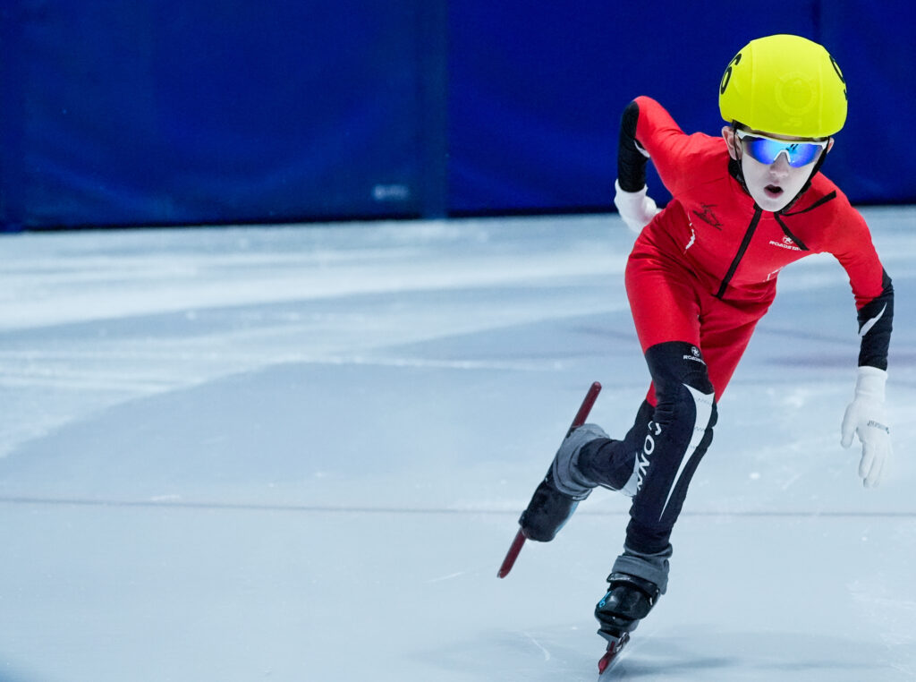 An athlete skating with helmet on the rink