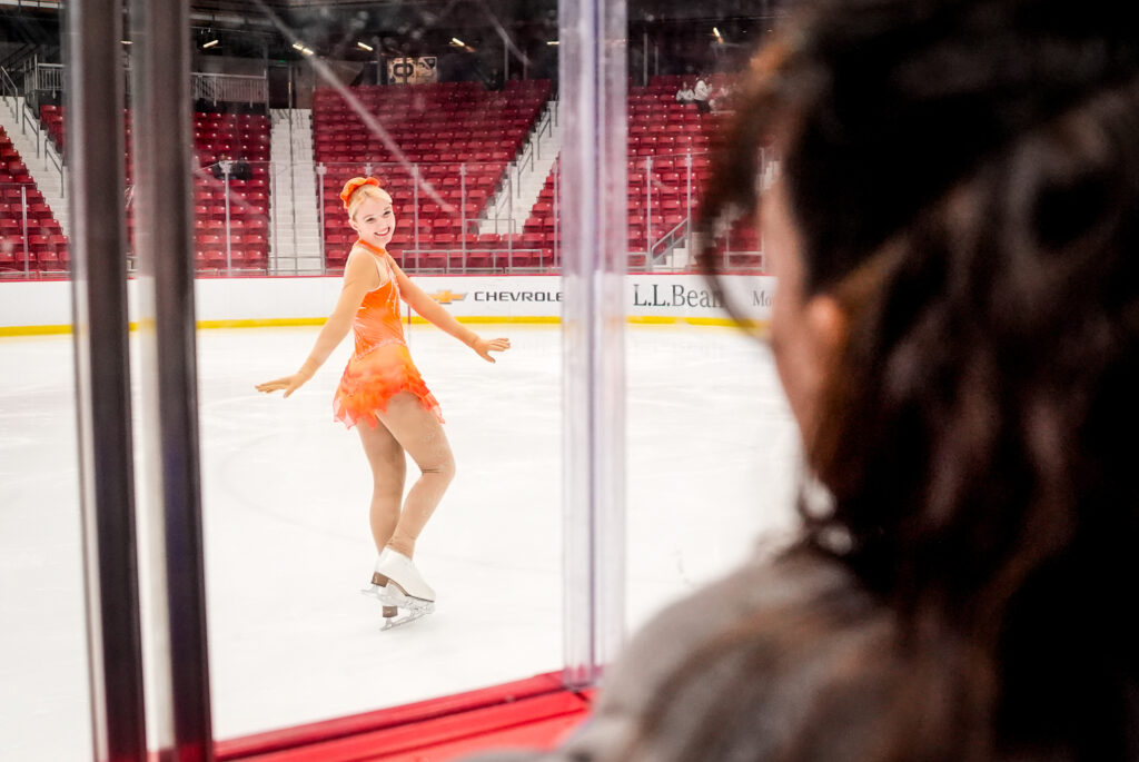 Two athletes skating on the rink