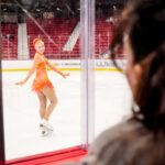 Two athletes skating on the rink