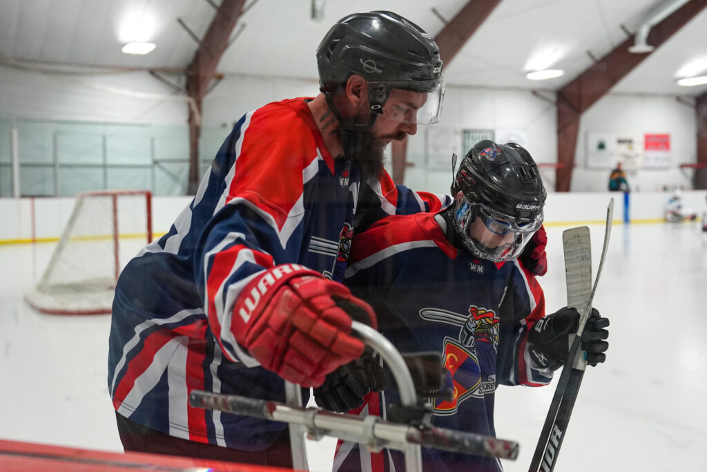 A group of athletes skating with helmet on the rink