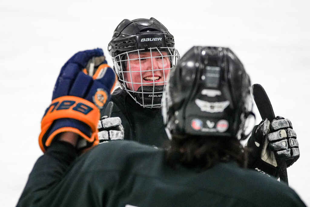 An athlete playing football with helmet on the field