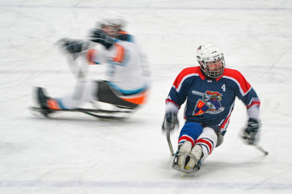 Two athletes competing in athletic event sports with helmet
