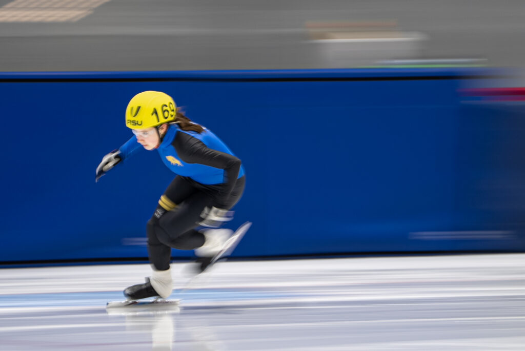 An athlete skating with helmet on the rink