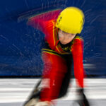 An athlete competing in athletic event sports with helmet in the snow