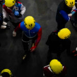 A group of athletes playing football with helmet on the field