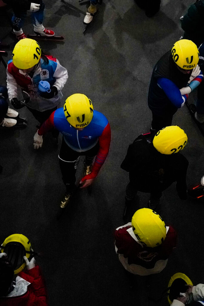 A group of athletes playing football with helmet on the field