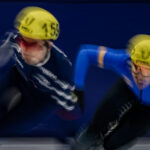 Two athletes competing in athletic event sports with helmet