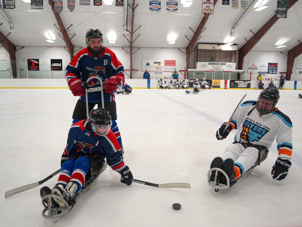 A group of athletes skating with helmet on the rink