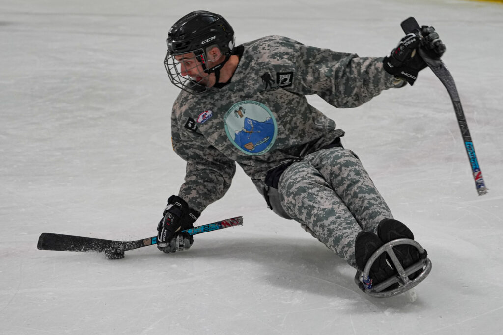 An athlete skating with helmet on the rink