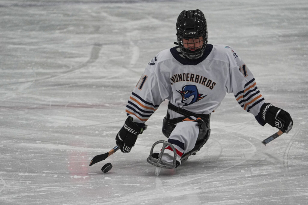 An athlete skating with helmet on the rink