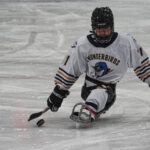 An athlete skating with helmet on the rink