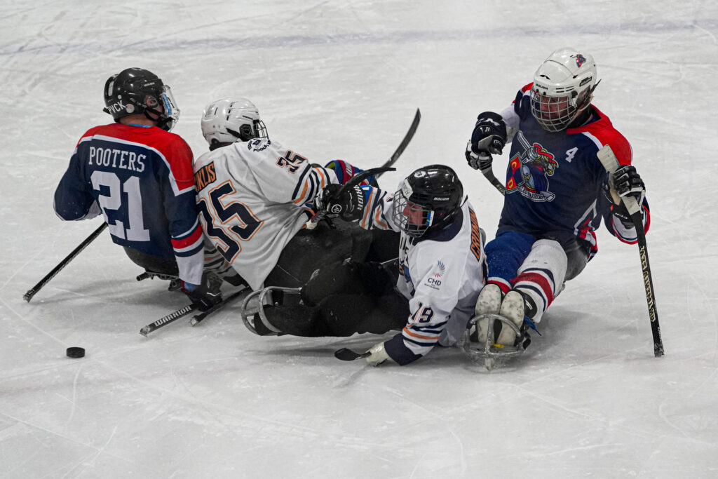 A group of athletes skating with helmet on the rink