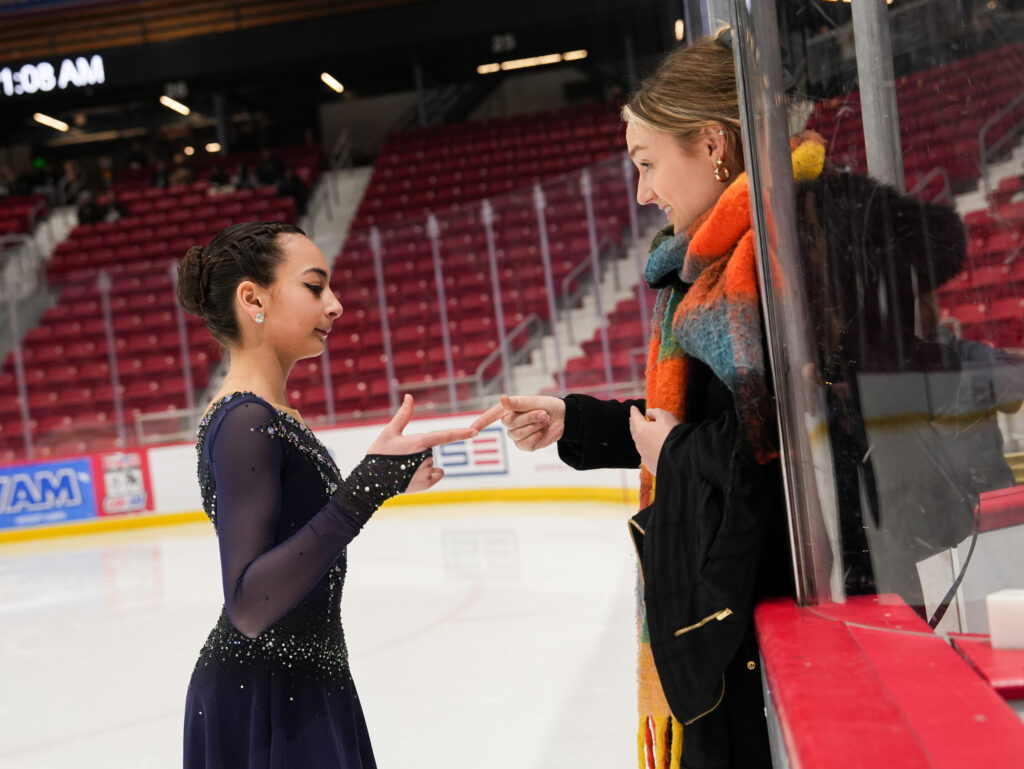 A group of athletes skating on the rink