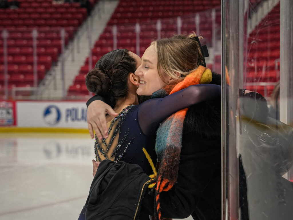 Two athletes skating on the rink