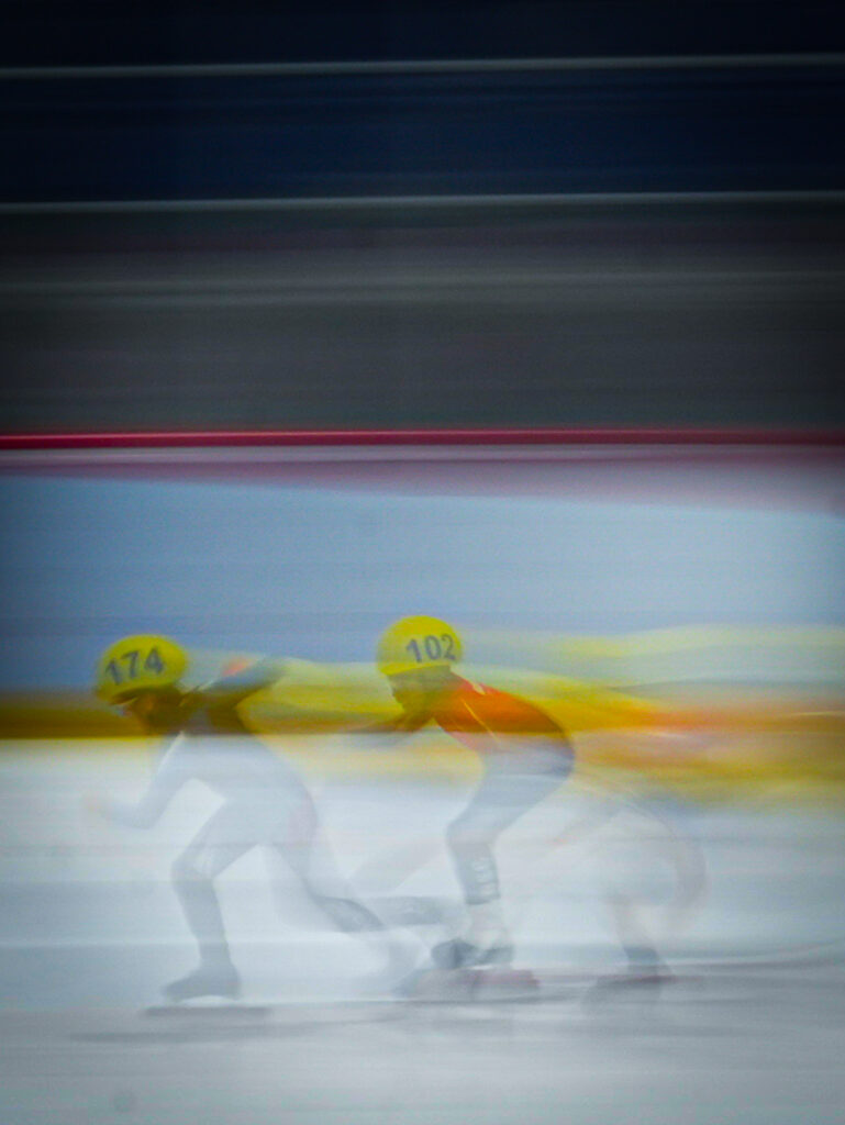 Two athletes skating on the rink