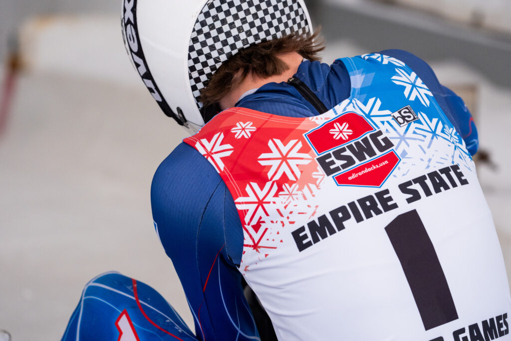 An athlete playing football with helmet on the field