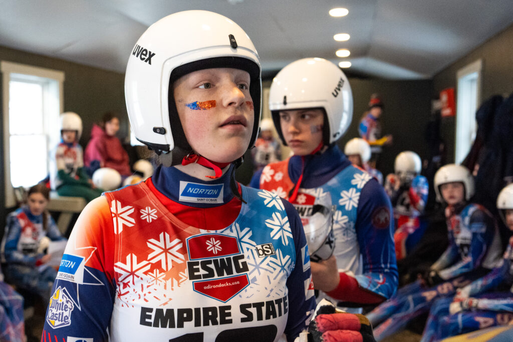 A group of athletes playing volleyball with helmet on the court