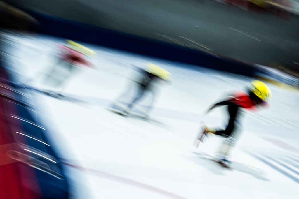 Two athletes competing in athletic event sports with helmet in the snow