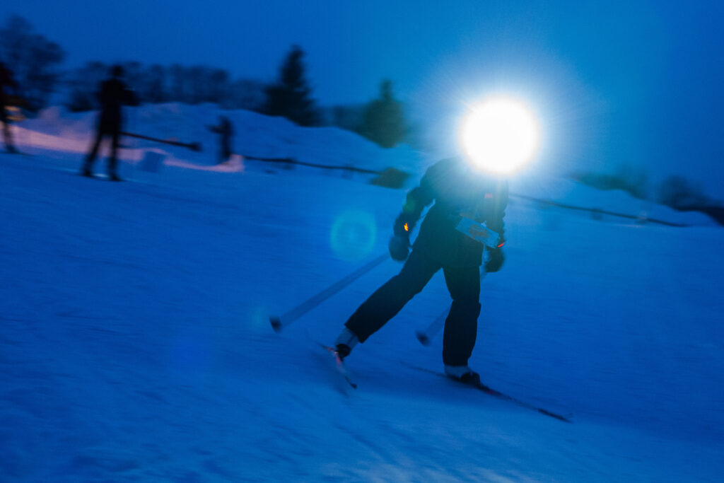 Two athletes skiing in the snow