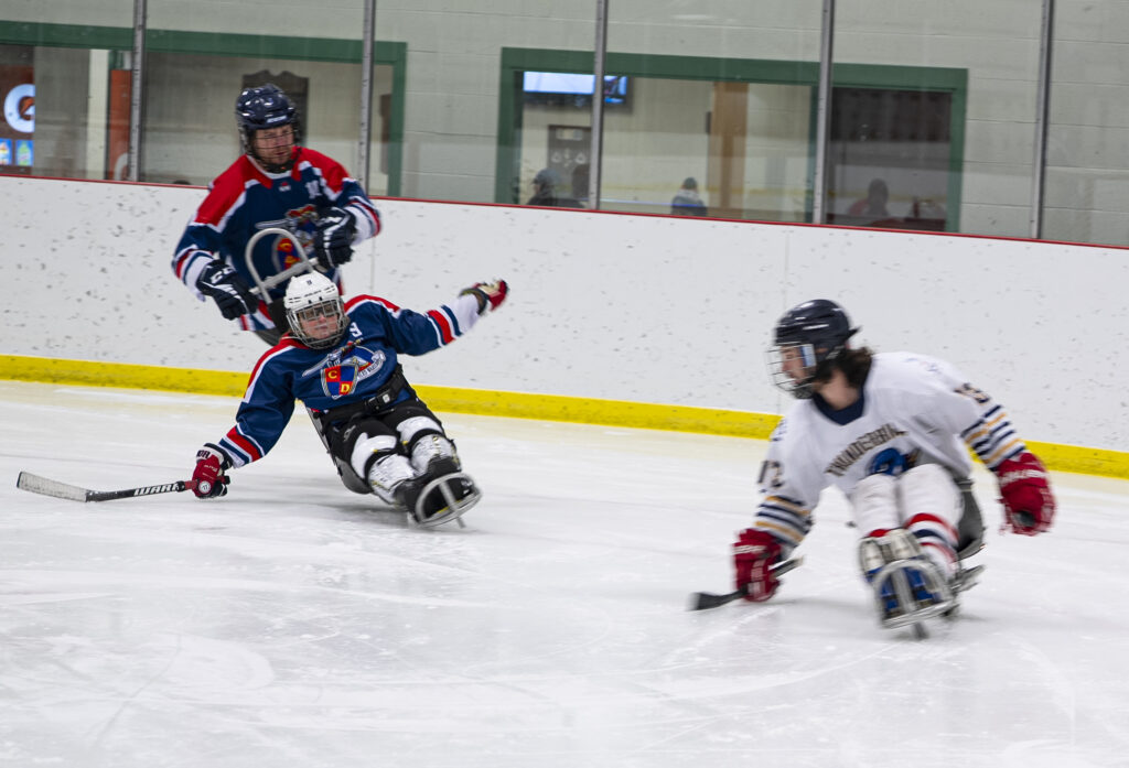 A group of athletes skating with helmet on the rink