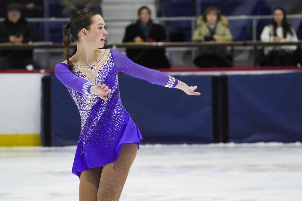 A group of athletes skating on the rink