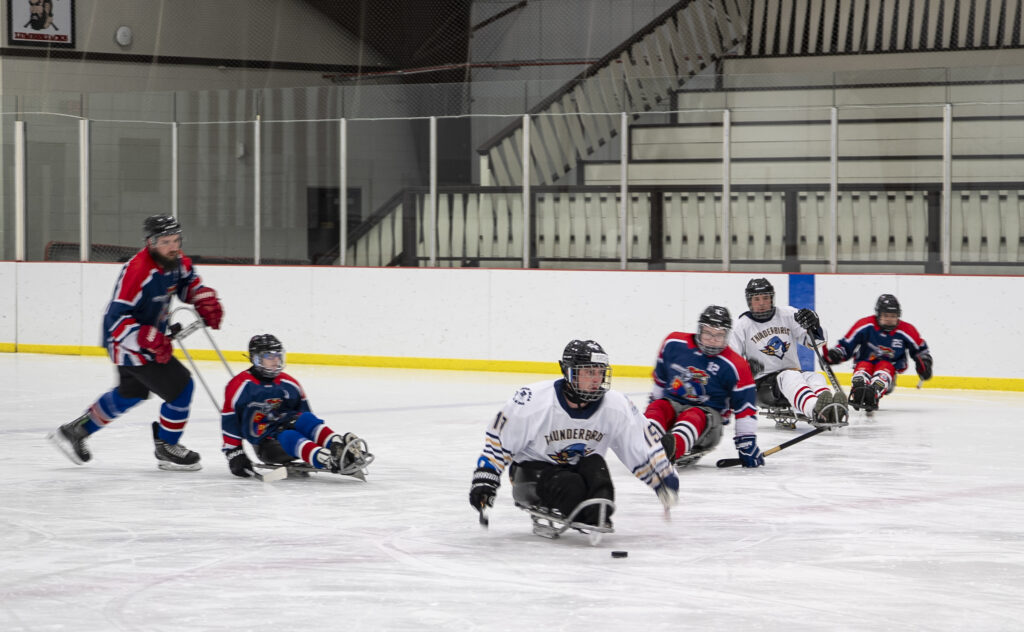 A group of athletes skating with helmet on the rink