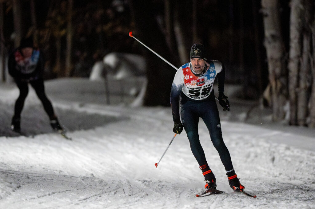 Two athletes skiing in the snow