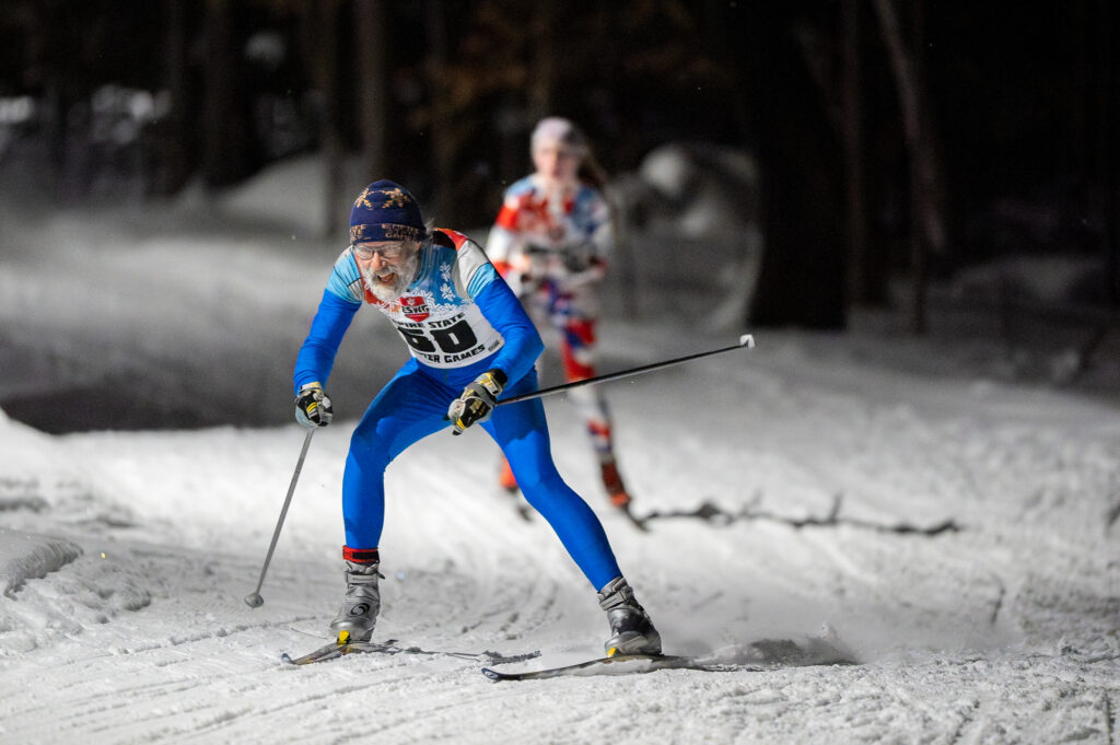 Two athletes skiing in the snow