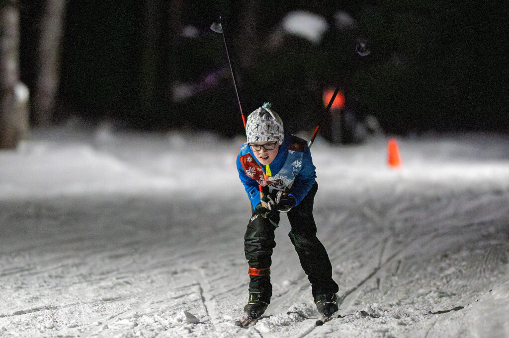 An athlete skiing with helmet in the snow