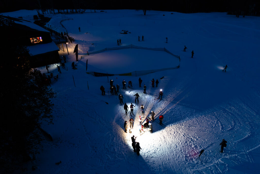 A group of athletes competing in athletic event sports with helmet in the snow
