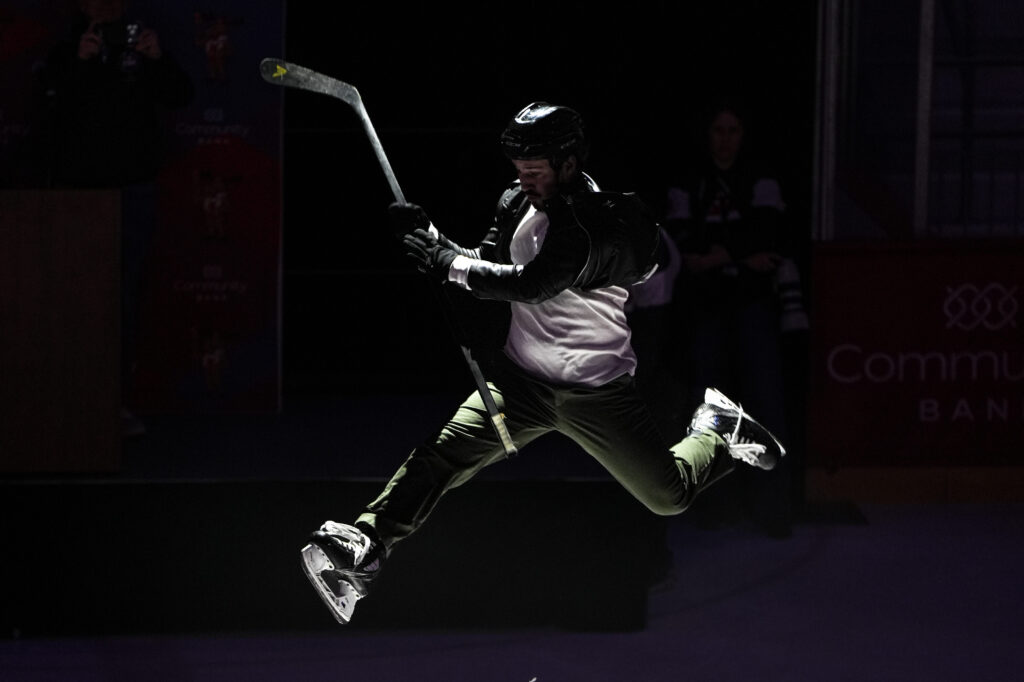 Two athletes competing in athletic event sports with helmet