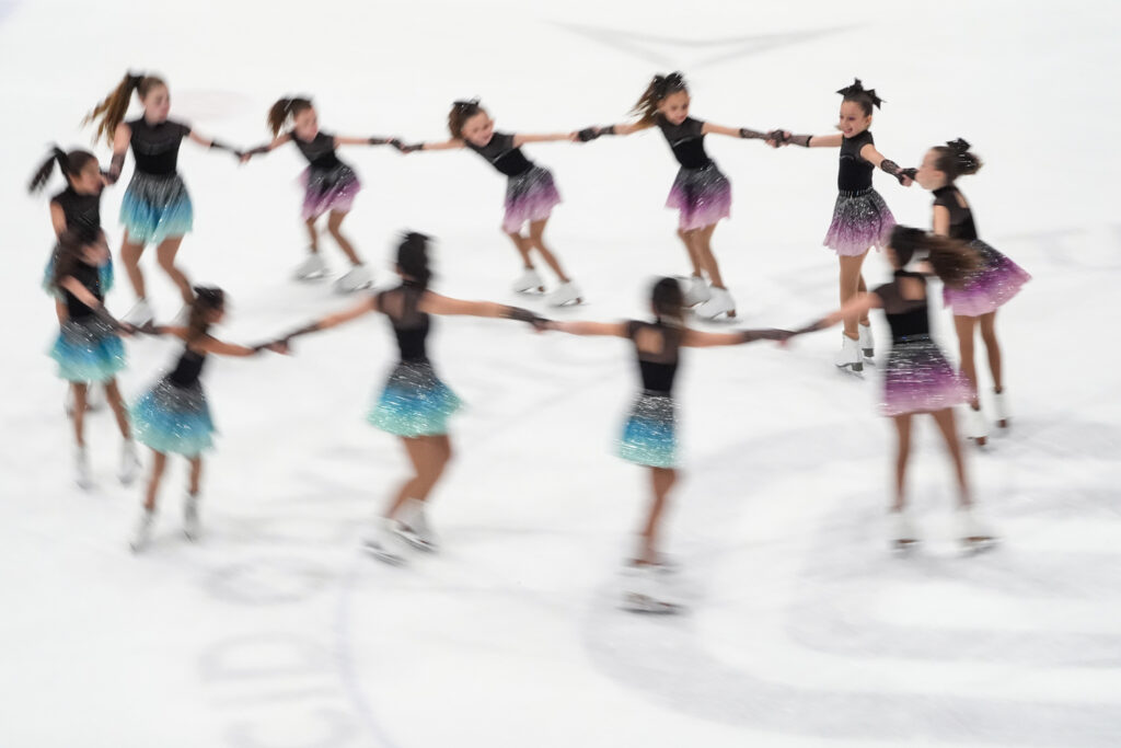 A group of athletes skating on the rink