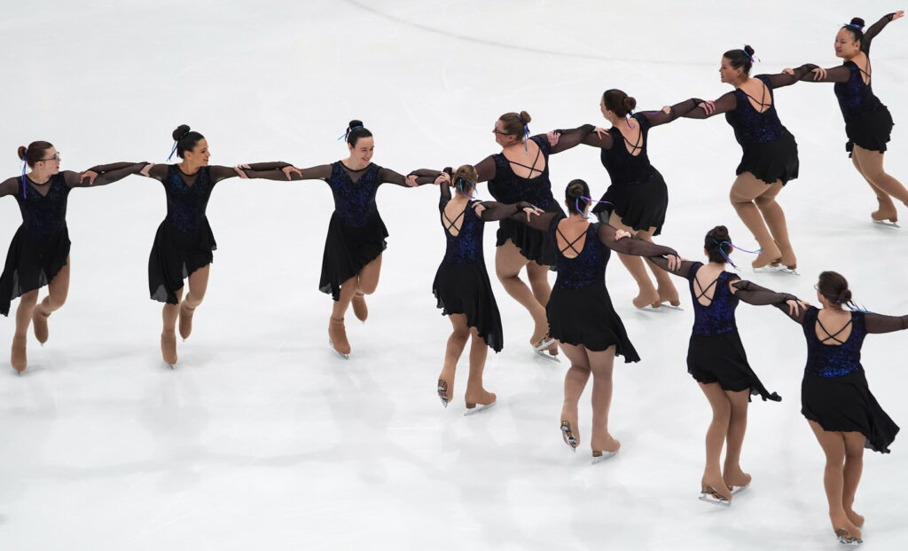 A group of athletes skating on the rink