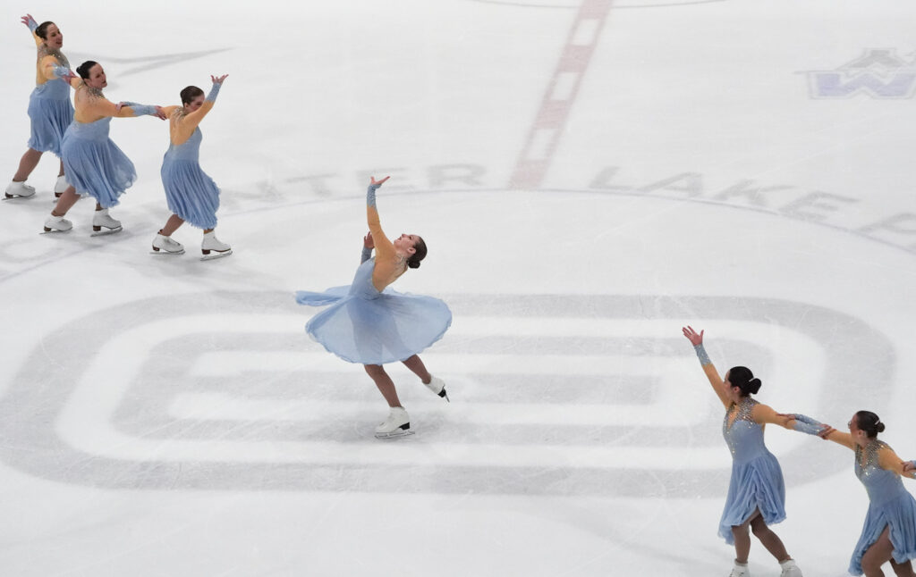 A group of athletes skating on the rink