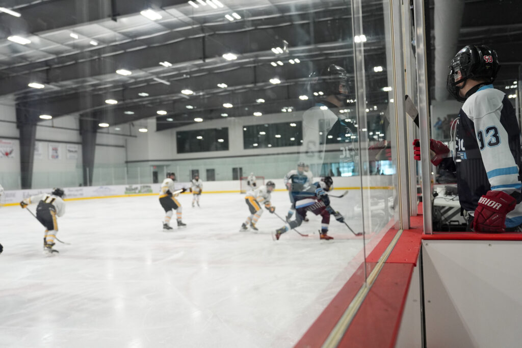 A group of athletes skating with helmet on the rink