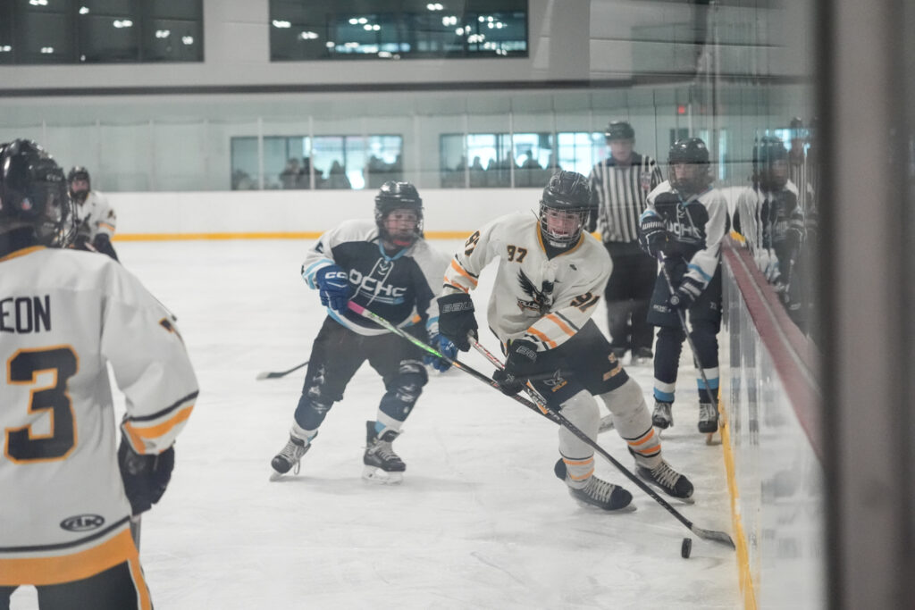 A group of athletes skating with helmet on the rink
