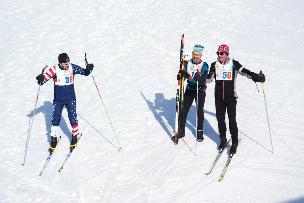 A group of athletes skiing in the snow