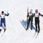 A group of athletes skiing in the snow