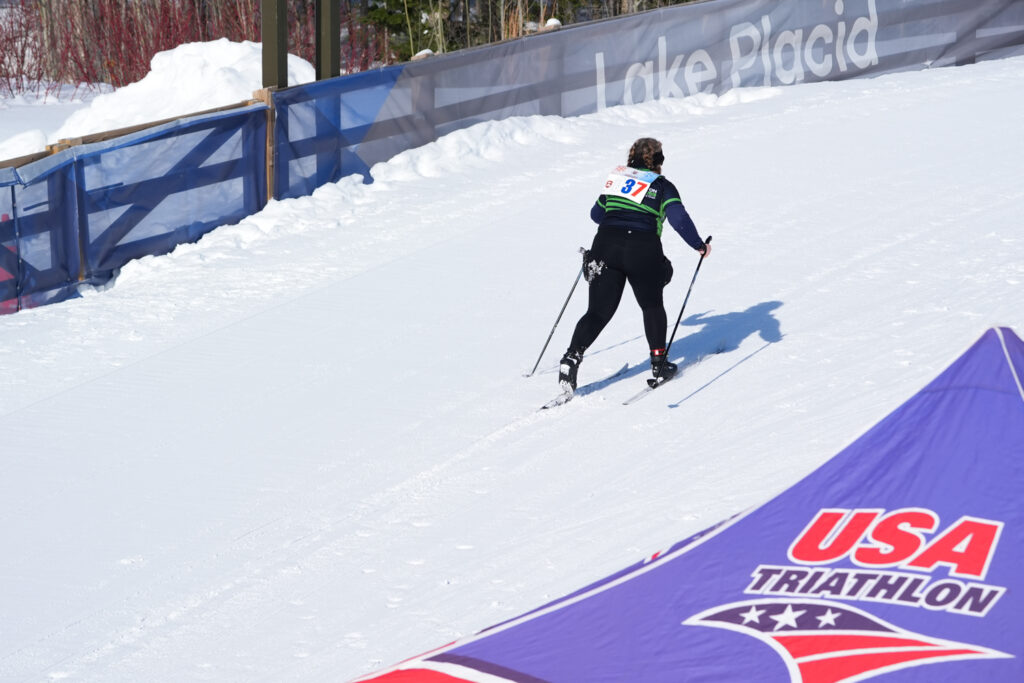 Two athletes skiing in the snow