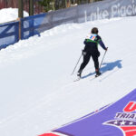 Two athletes skiing in the snow