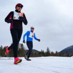 Two athletes competing in athletic event sports in the snow