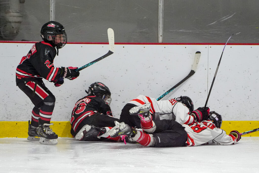 A group of athletes skating with helmet on the rink